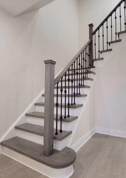 Staircase with white oak treads and a black metal railing